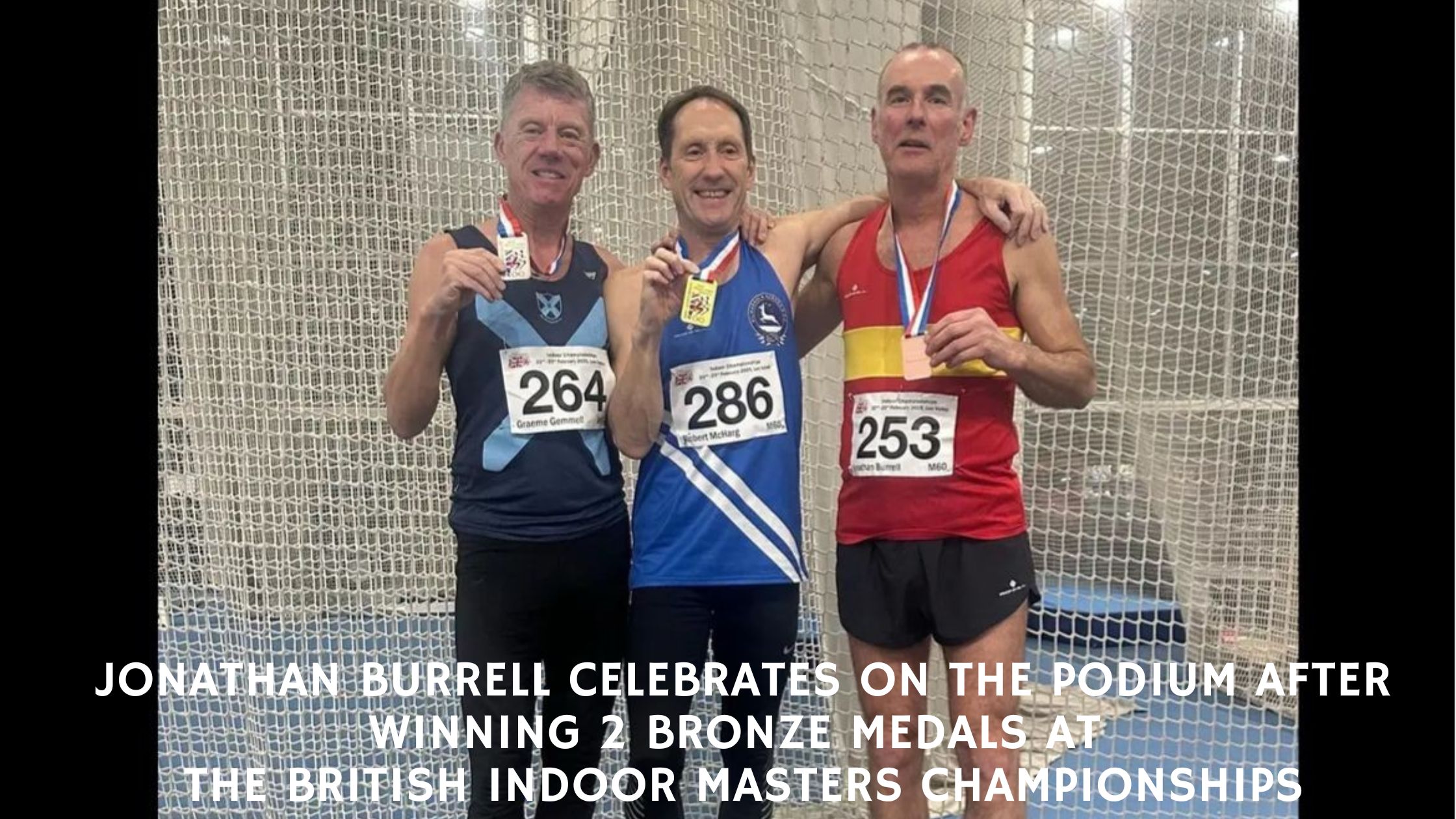 Lewes Athletic Club's Jonathan Burrell celebrates on the podium after winning two bronze medals at the British Indoor Masters Championships.